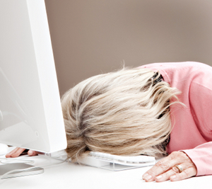 Tired Woman Asleep In Front of Her Keyboard